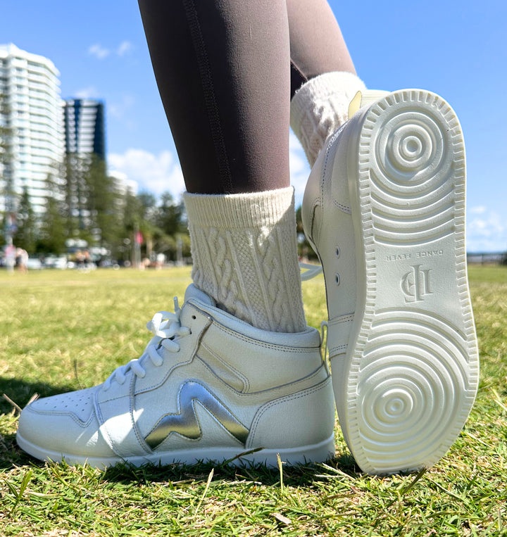Premium women's high top dance sneaker in white leather featuring raised duo pivot spin spots out sole