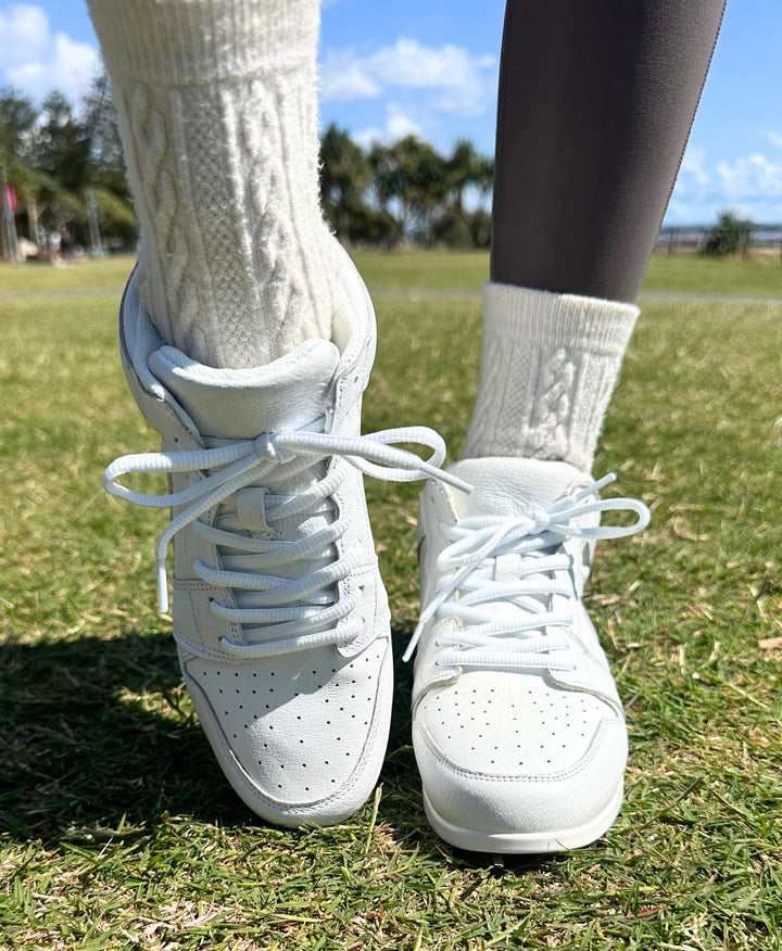 Premium women's high top dance sneaker in white leather featuring raised duo pivot spin spots out sole