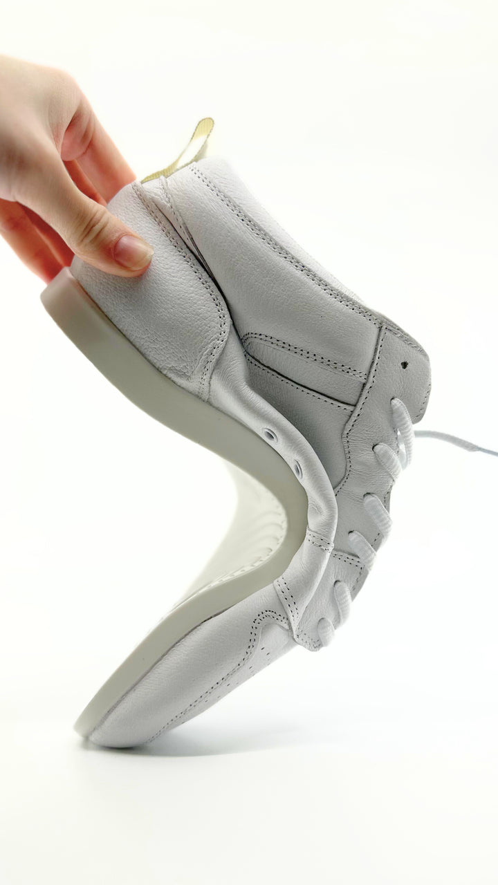Premium women's high top dance sneaker in white leather featuring raised duo pivot spin spots out sole