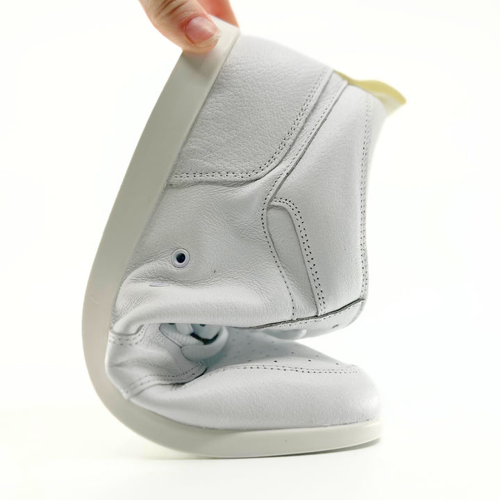 Premium women's high top dance sneaker in white leather featuring raised duo pivot spin spots out sole